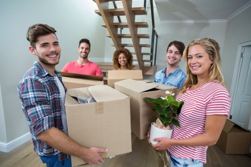Professional movers packing items in Storage Colliers Wood